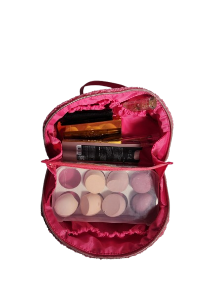 Pink textured makeup bag open with beauty essentials