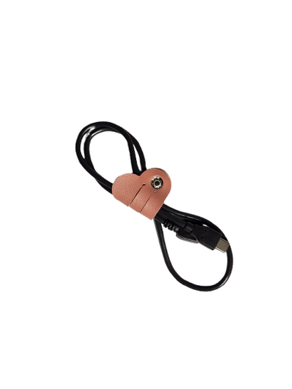 Heart-shape tech cord organizer wrapped around charging cable