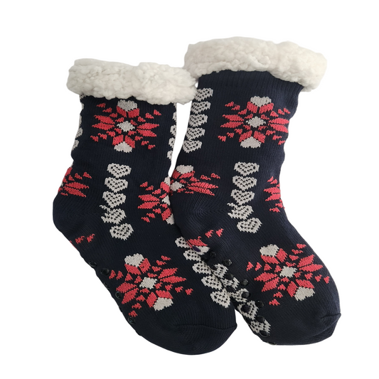 Pair of navy-blue fleece-lined slipper socks featuring red and white snowflake patterns, white hearts, fluffy white cuffs, and black non-slip grips.