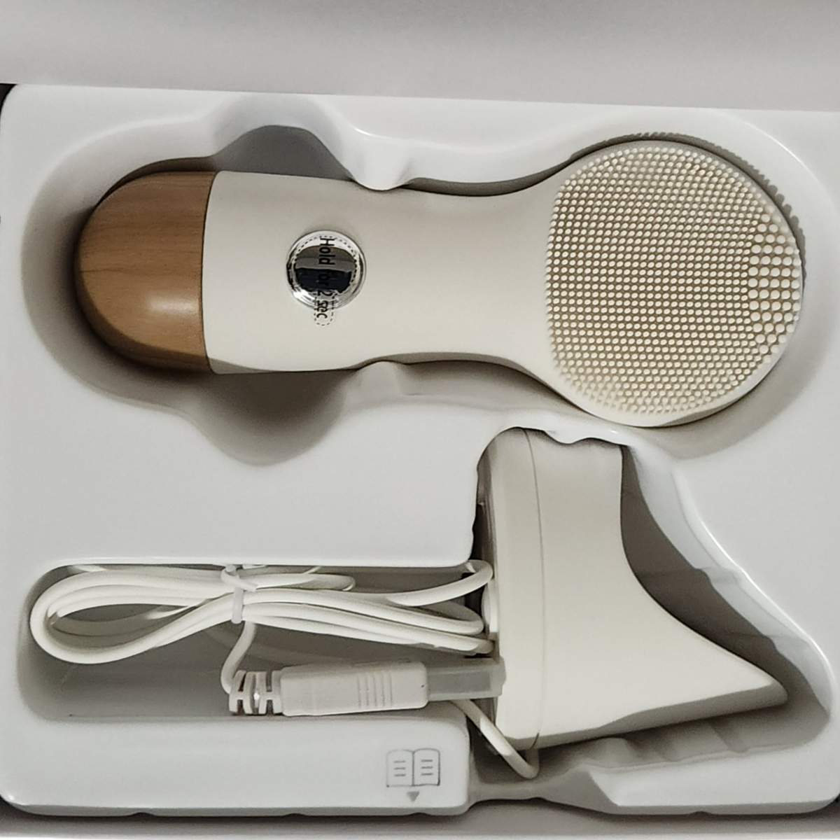 NION BEAUTY OPUS LUXE facial cleaning device in original packaging with silicone cleaning head, charging cord, and stand