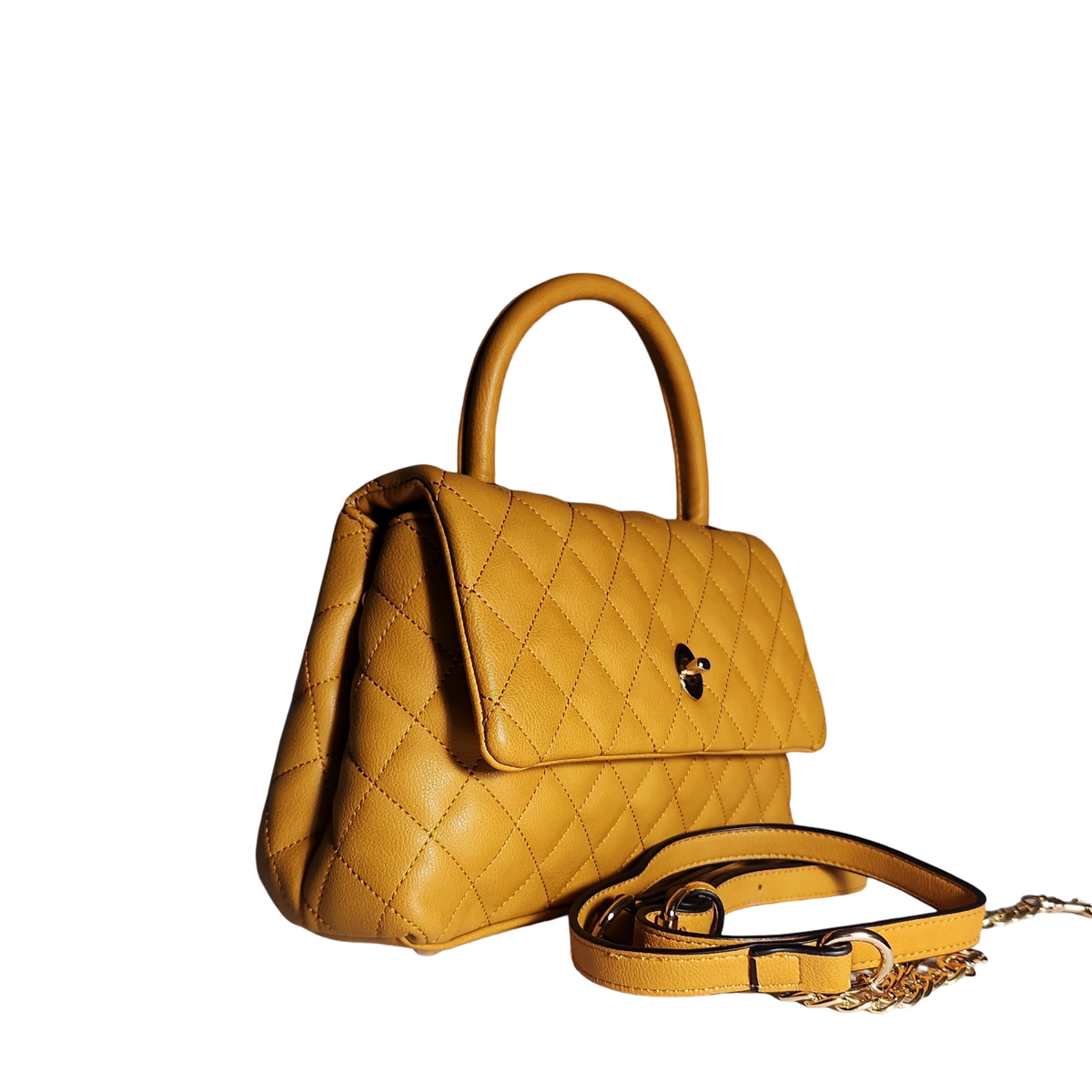 Side view of mustard yellow quilted mini satchel handbag showing it structed shape, top handle, and detachable shoulder strap.