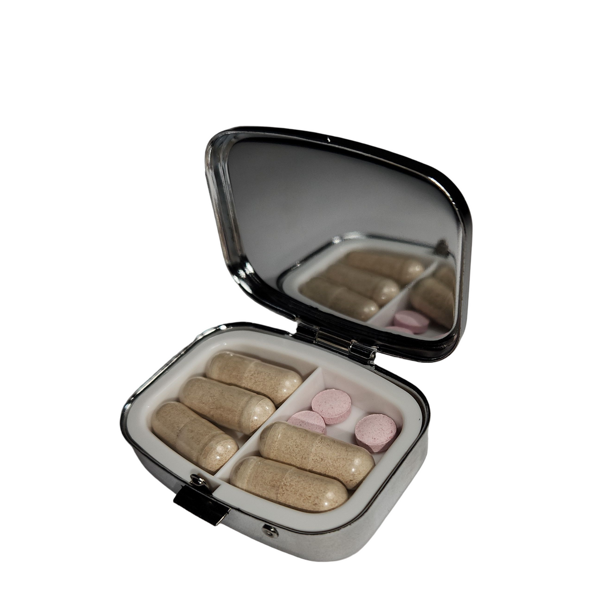 Open decorative pill organizer viewed with at an angle, showing a built in- mirror, divided compartments, and a hinged metal lid.