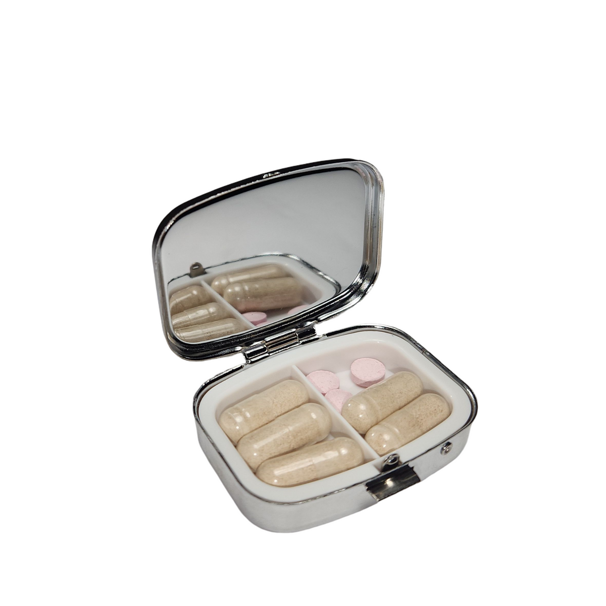 Open decorative pill organizer viewed with at an angle, showing a built in- mirror, divided compartments, and metal clasp.