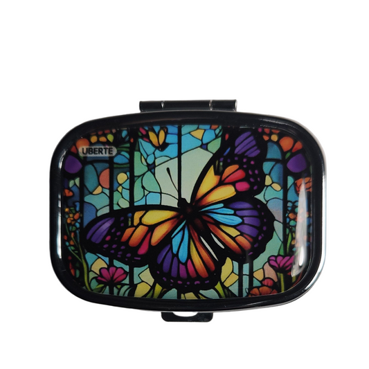Butterfly decorative pill organizer featuring a colorful butterfly design with built-in mirror and two compartments.