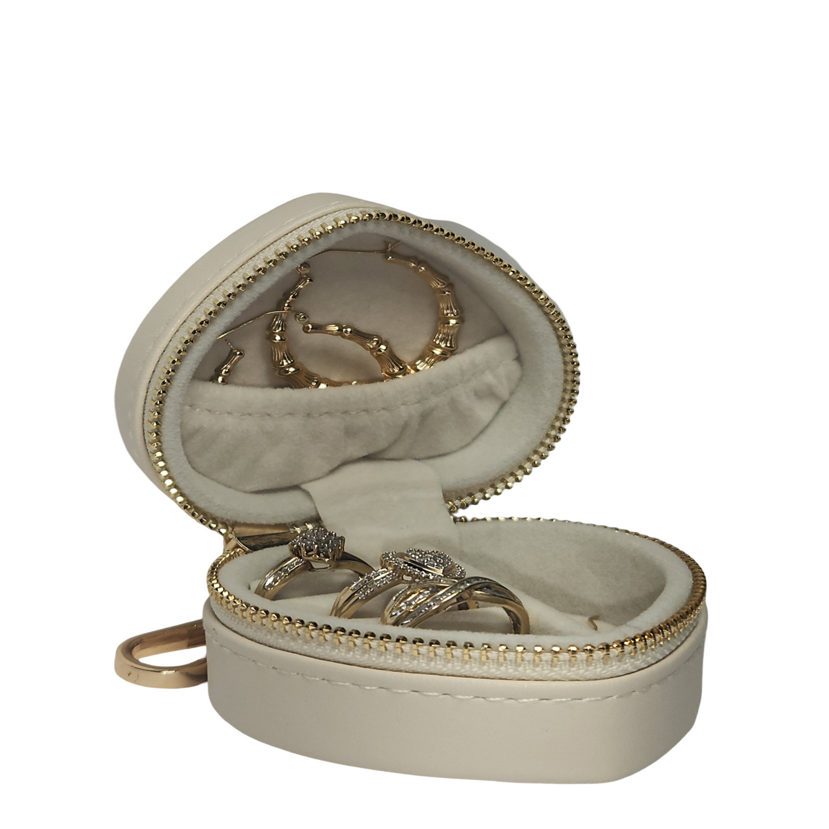 Open cream heart-shaped jewelry organizer displaying rings and earrings in soft- lined compartments, with gold-ton zipper and keychain clip.