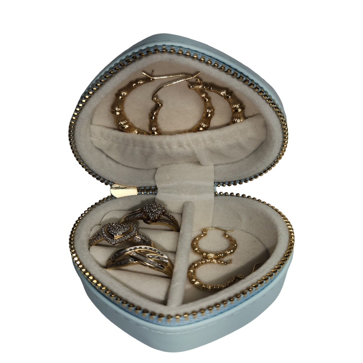 Open blue heart-shaped jewelry organizer showing rings and earrings inside its soft-lined compartments.