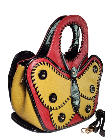 Butterfly-shaped handbag with red, yellow, and black design side view with detachable strap